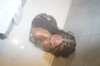 a woman in a bath tub with dreadlocks
